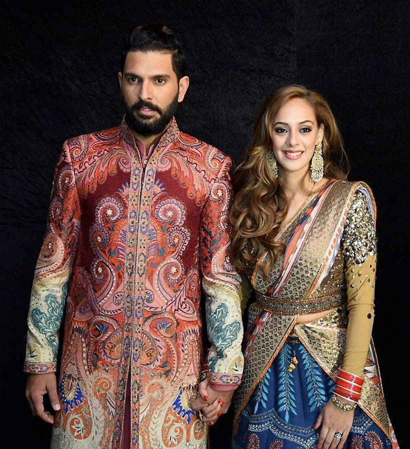 New Delhi: Cricketer Yuvraj Singh and his wife Hazel Keech pose for a photograph during their reception party in New Delhi on Wednesday. PTI Photo (PTI12_7_2016_000335B)