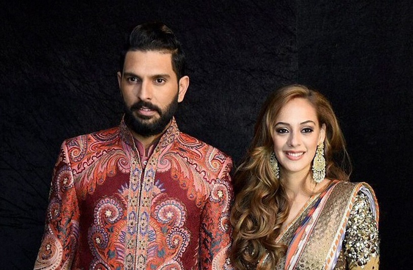 New Delhi:  Cricketer Yuvraj Singh and his wife Hazel Keech pose for a photograph during their reception party in New Delhi on Wednesday. PTI Photo (PTI12_7_2016_000335B)