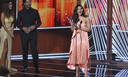 Jamie Chung and Adam Rodriguez look on from left as Priyanka Chopra accepts the award for favorite TV drama actress at the People's Choice Awards at the Microsoft Theater on Wednesday, Jan. 18, 2017, in Los Angeles. (Photo by Vince Bucci/Invision/AP)