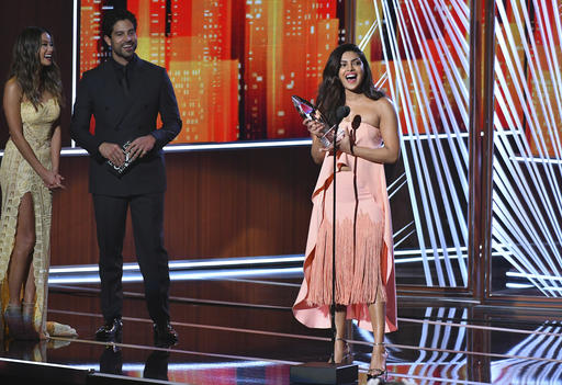 Jamie Chung and Adam Rodriguez look on from left as Priyanka Chopra accepts the award for favorite TV drama actress at the People's Choice Awards at the Microsoft Theater on Wednesday, Jan. 18, 2017, in Los Angeles. (Photo by Vince Bucci/Invision/AP)